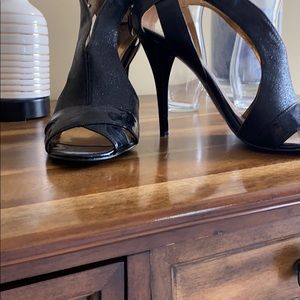 Black, Sexy, High heels a/ a back zip. Tiny nick.